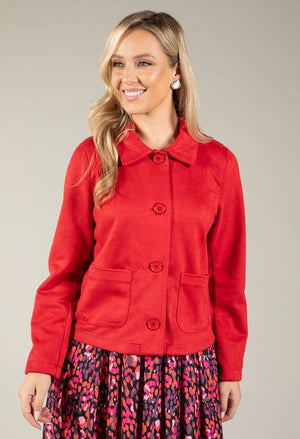 A woman modeling a bright red cropped button-front jacket with a pointed collar and front patch pockets.
