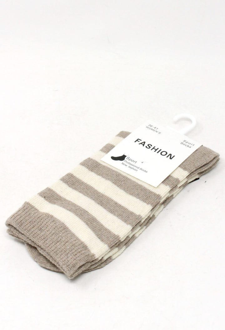 A pair of folded striped socks with beige and off-white horizontal bands, attached to a white paper tag that reads 'FASHION', on a plain white background.