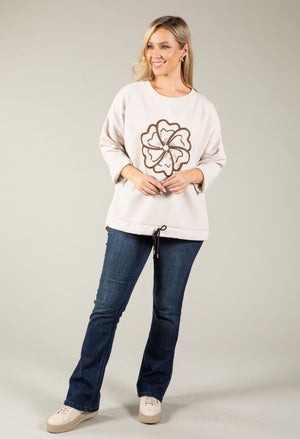 beige sweatshirt with flower