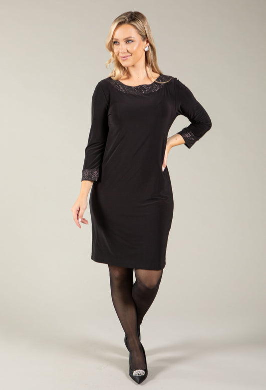 Woman wearing the sparkle trim short dress with glittering trim detail
