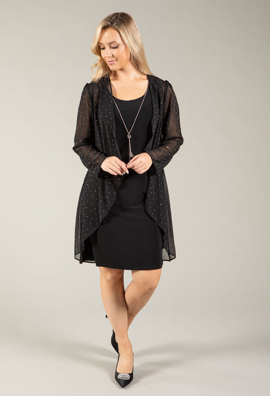 A woman modeling a sheer black long-sleeve open-front cardigan with subtle silver-tone polka dots over a black dress, against a solid light gray studio background.