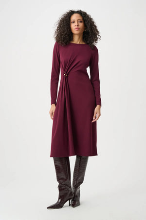 Woman wearing the midi wrap dress with button detail and flattering wrap waist