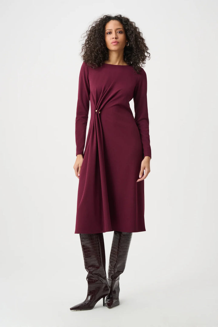 Woman wearing the midi wrap dress with button detail and flattering wrap waist