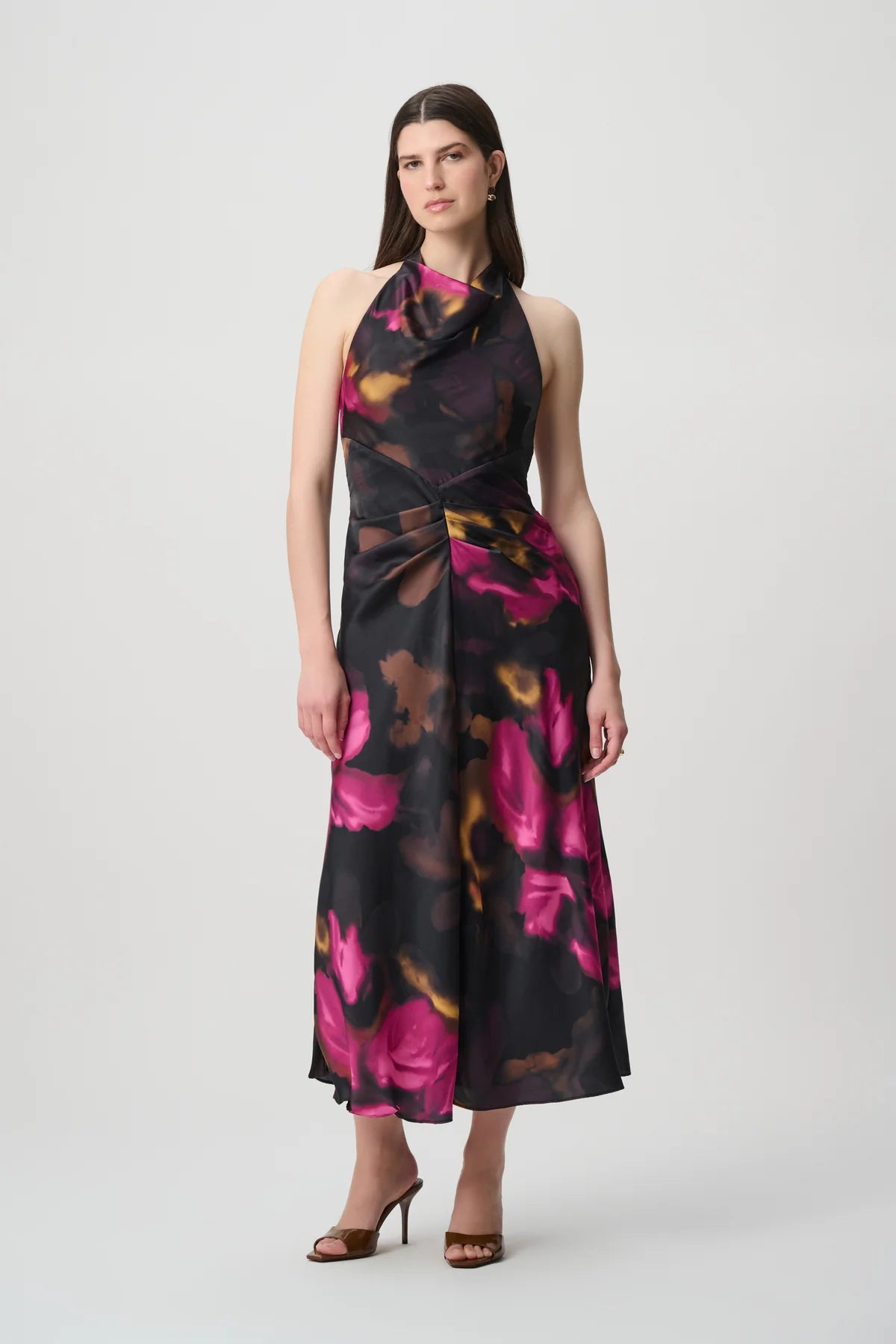 Woman wearing the floral satin halter midi dress with a halter neckline and midi-length skirt