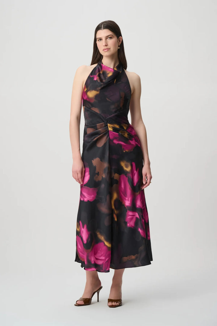 Woman wearing the floral satin halter midi dress with a halter neckline and midi-length skirt