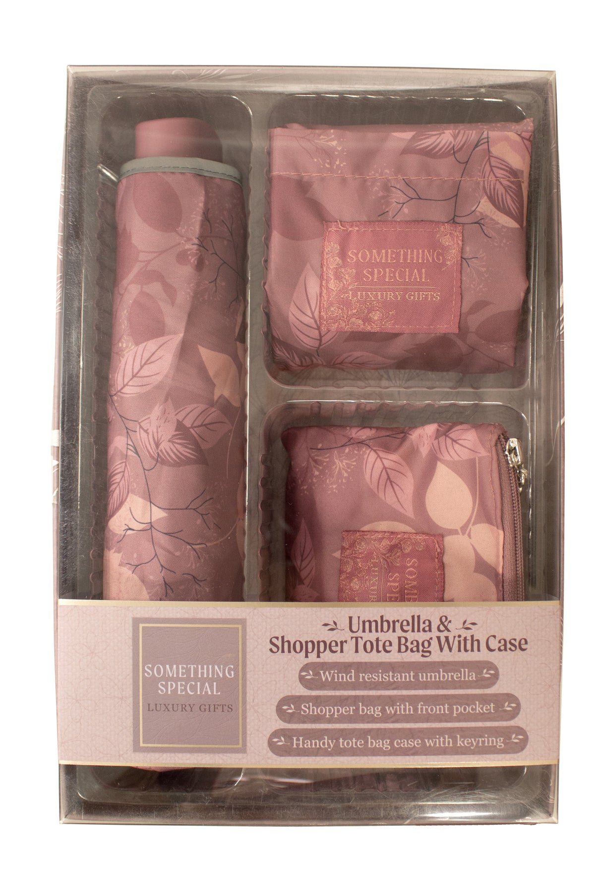 A packaged gift set containing a pink patterned umbrella and two matching shopper tote bags with cases, shown inside a clear plastic box with a branded paper label.