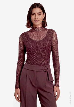 A model wearing a sheer, long-sleeve mock-neck top with a textured snakeskin pattern in a deep burgundy shade.