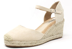 A beige espadrille style wedge sandal with a crochet look toe and an adjustable ankle strap.