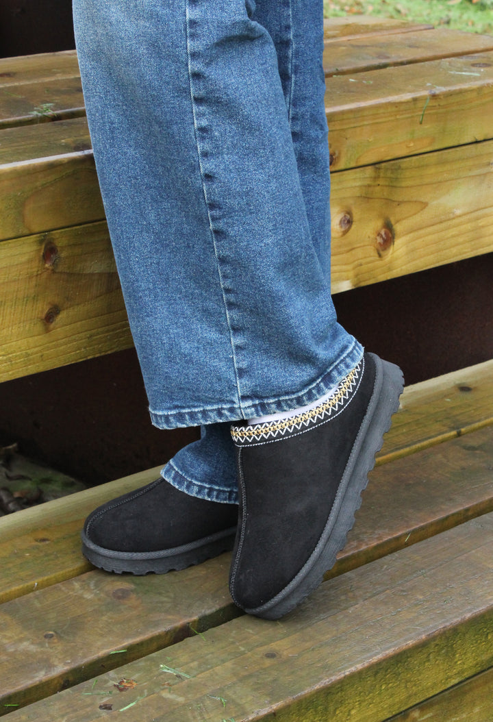 embroidered slip on shoe one a model wearing blue denim jeans