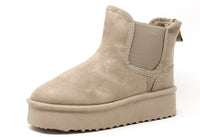 a beige faux suede slip on Chelsea slip boot with platform sole on a white background