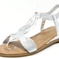 Silver sandal with a beige sole on a white background