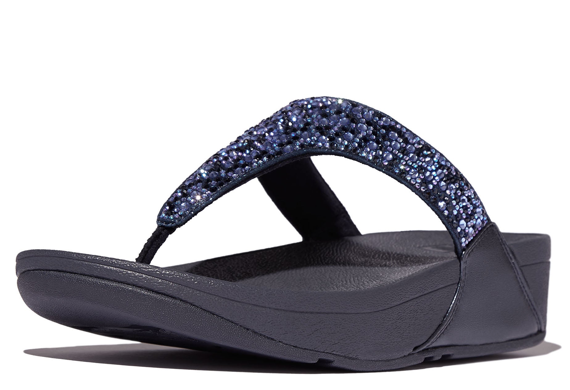 A navy Fit Flop Lulu Stone Hot-Fix sandal with a studded strap and a micro-wobbleboard design.