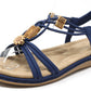 Blue sandal with wooden look beads on a white background