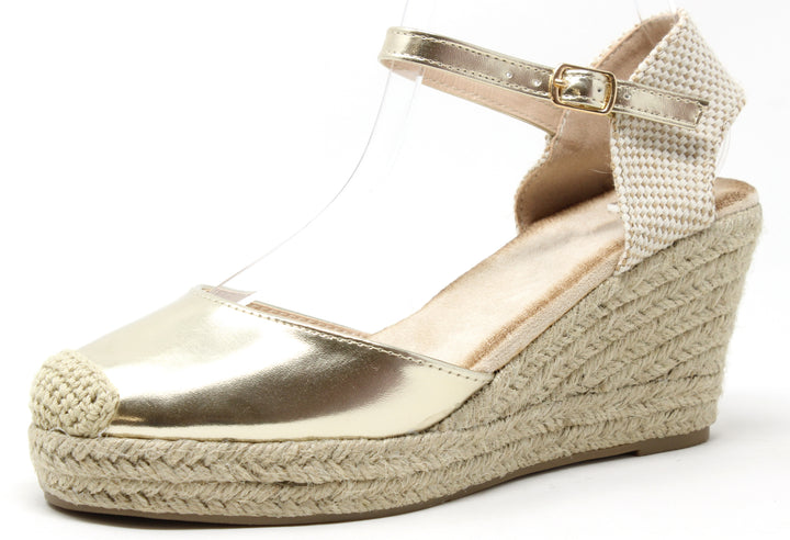 Gold wedge sandal with espadrille sole on a white background