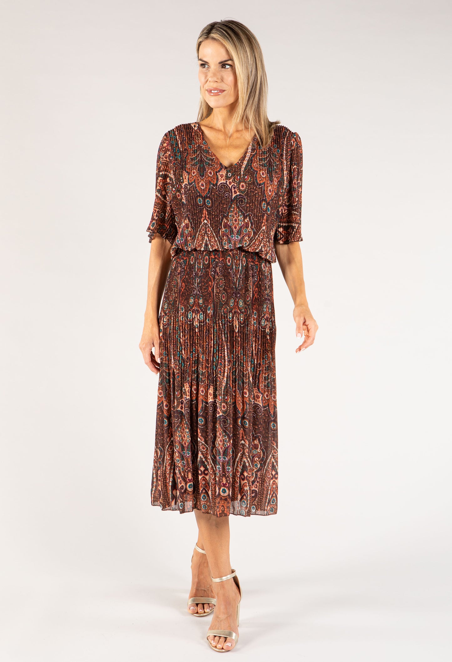 Woman wearing a patterned dress on a white background