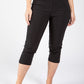 Person wearing black capri pants on a white background