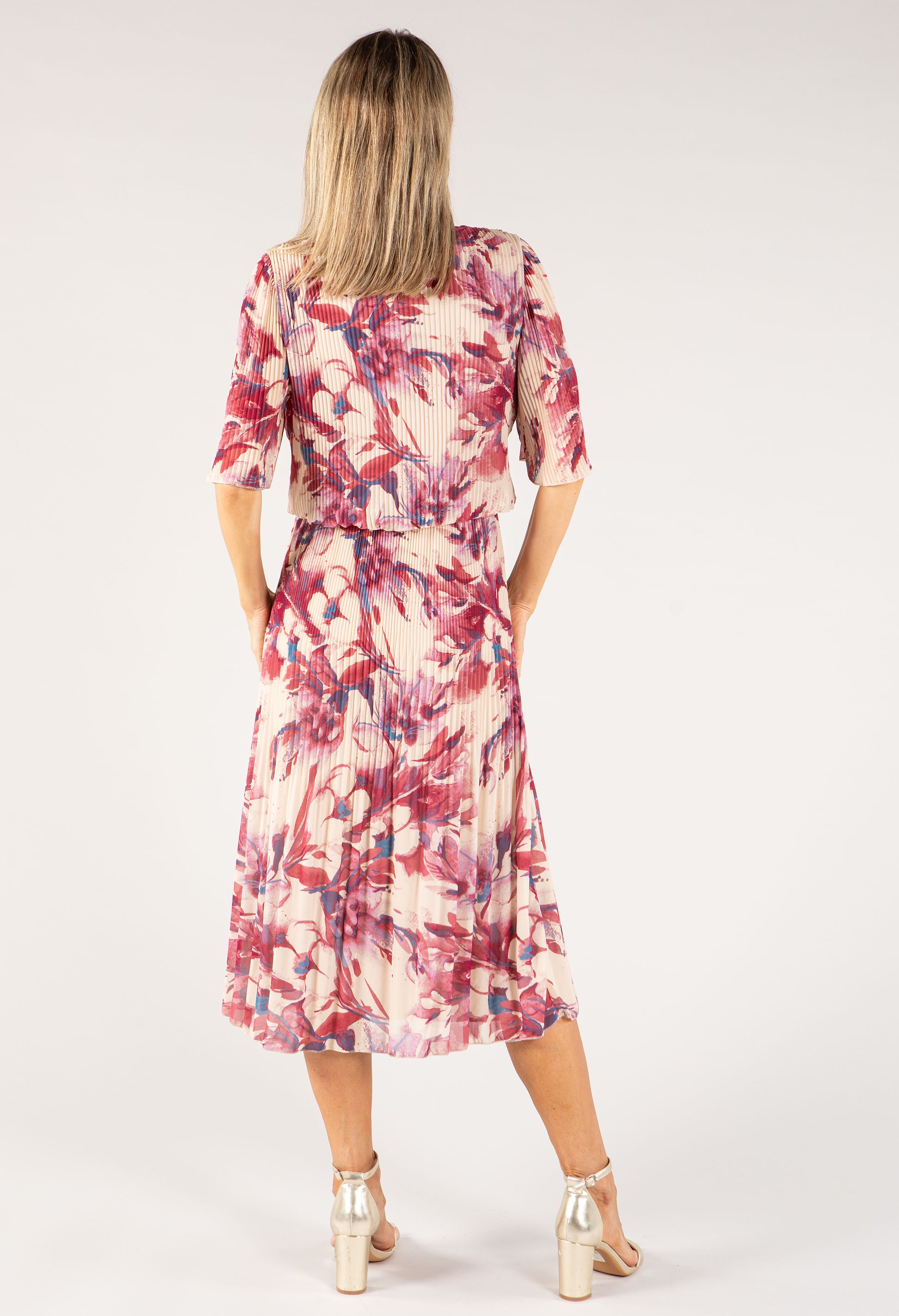 Woman wearing a floral dress on a white background