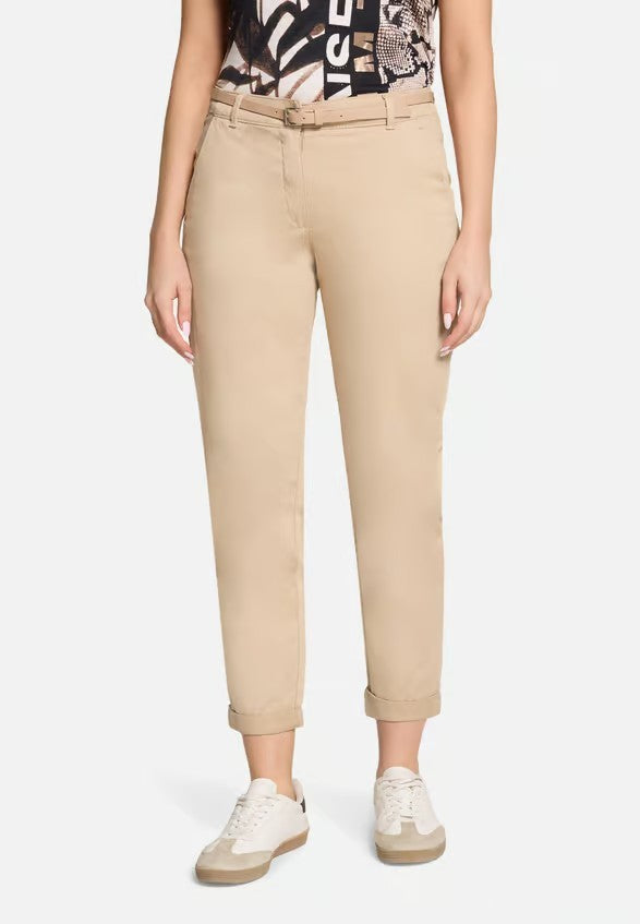 Person wearing beige pants on a white background