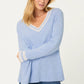 woman wearing a light blue knit jumper
