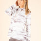 Woman wearing a white and gray striped hoodie on a beige background