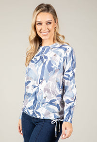 woman wearing a blue leaf patterned sweatshirt
