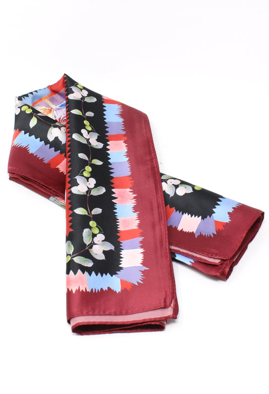 Folded scarf with colorful pattern on a white background