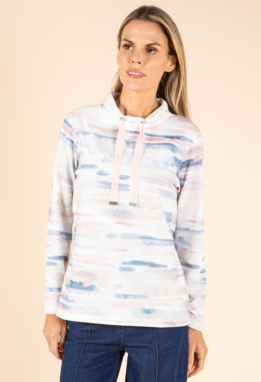 Woman wearing a striped hoodie with a beige background