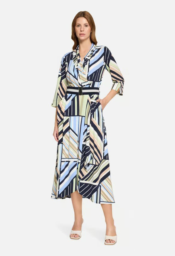 Woman wearing a patterned dress on a white background