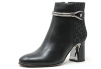 Black ankle boot with leopard print strap and block heel on a white background