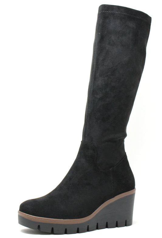 Black knee-high boot with a wedge sole on a white background