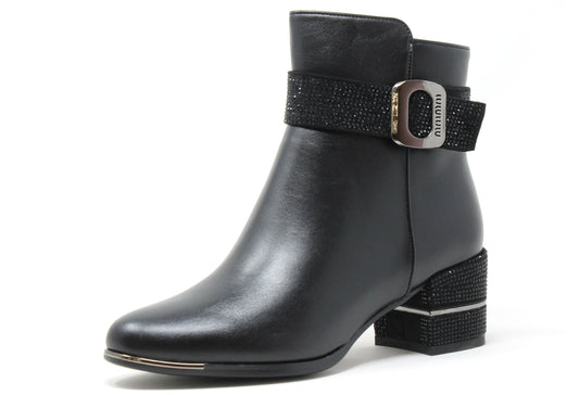 Black ankle boot with decorative buckle on a white background