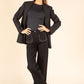 Woman wearing a black blazer and pants on a beige background