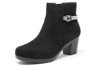 Black ankle boot with a decorative buckle on a white background