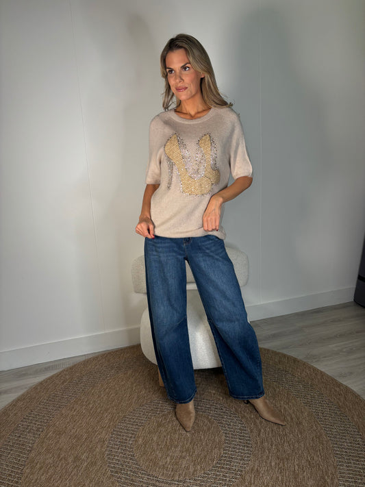 woman wearing soft knit top with diamante detail