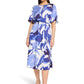 Woman wearing a blue floral dress on a white background