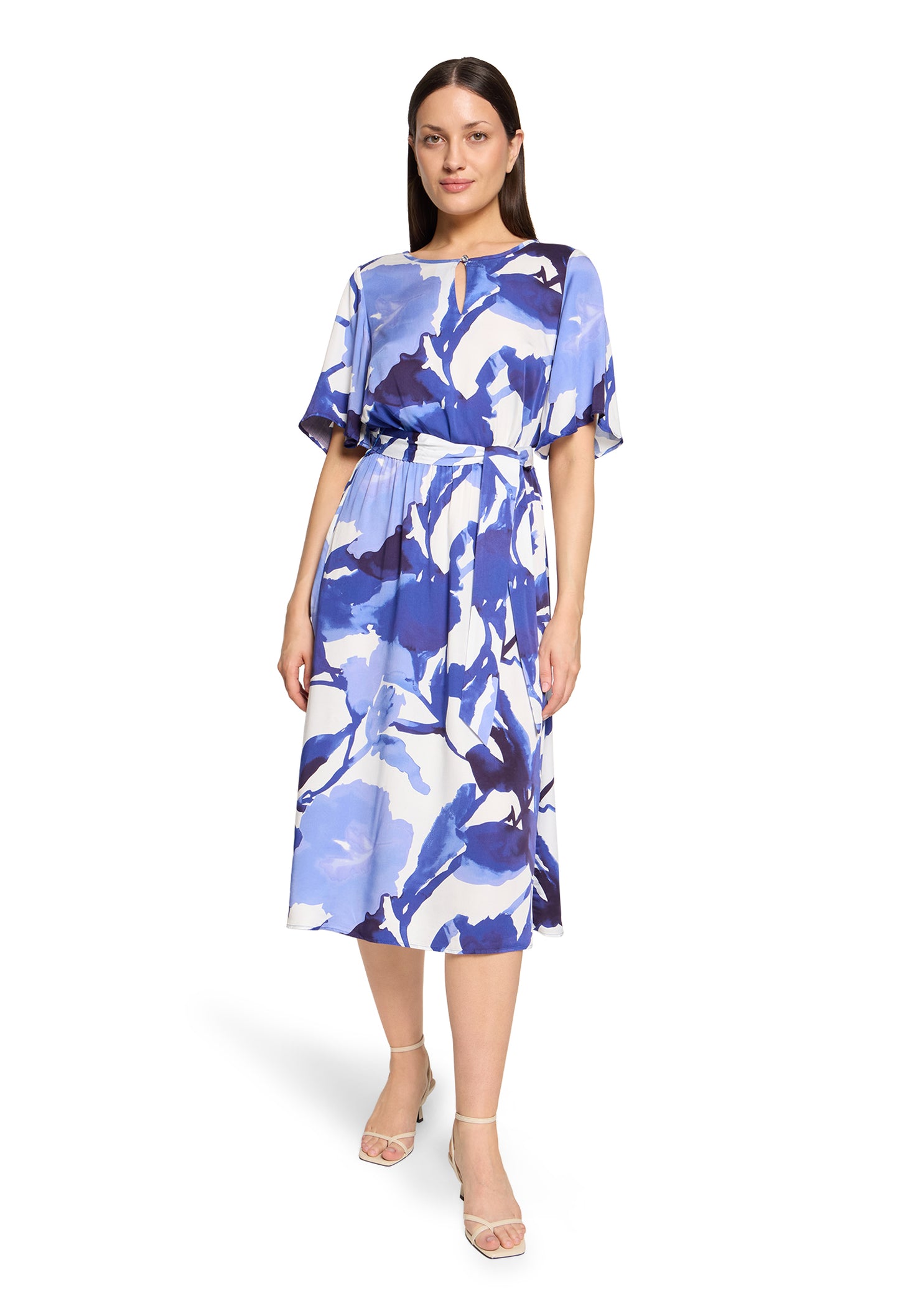 Woman wearing a blue floral dress on a white background