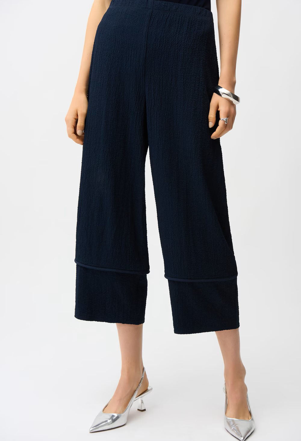 Navy blue wide-leg pants worn by a person on a white background
