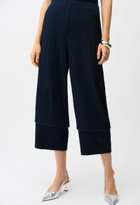 Navy blue wide-leg pants worn by a person on a white background