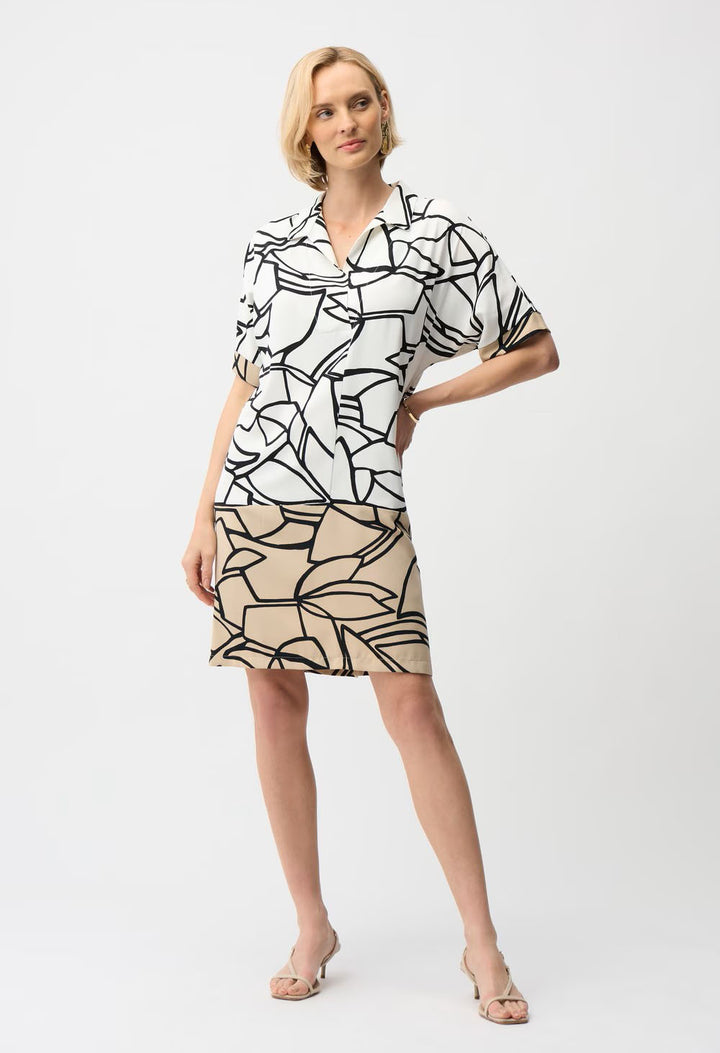 Woman wearing a black and white patterned dress on a white background