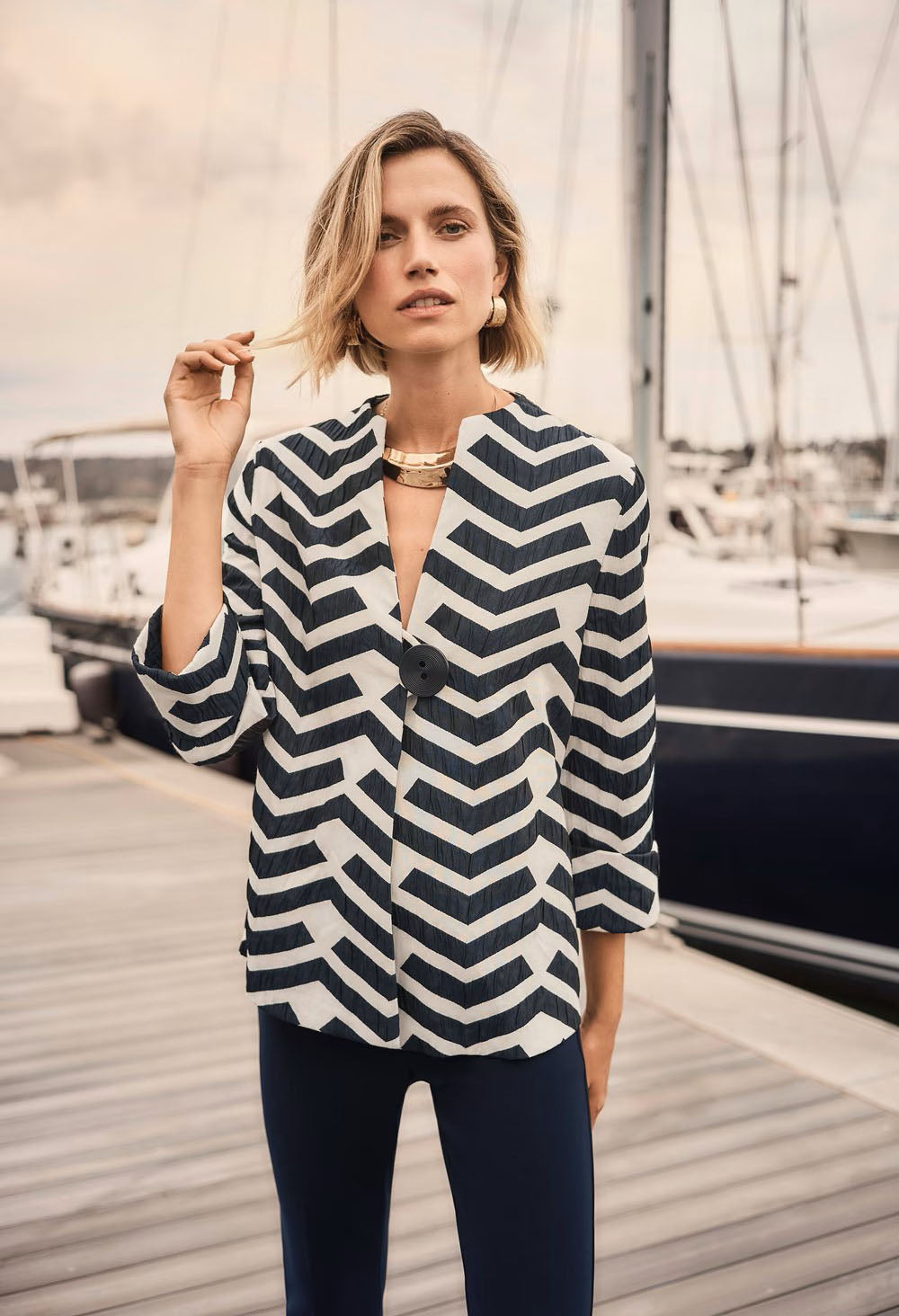 woman wearing a zig zag design jacket on a marina