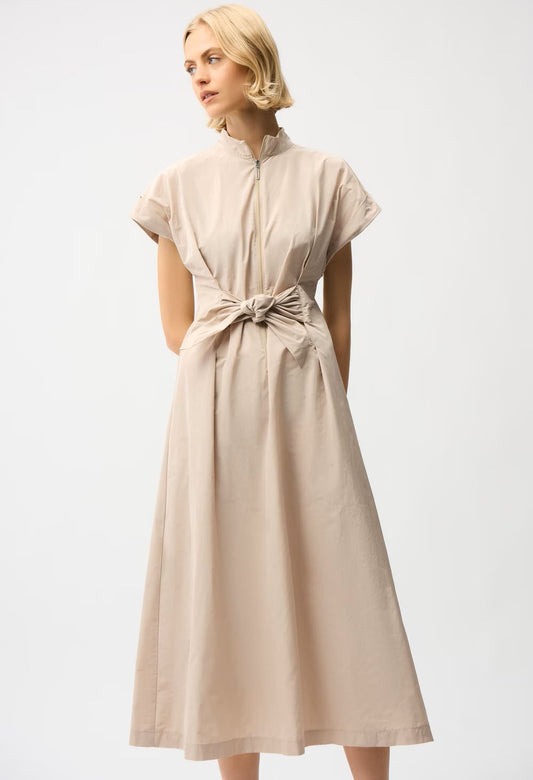 woman wearing beige wrap style dress with front zip