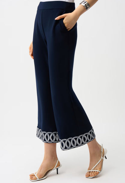 Navy blue pants with decorative hem on a white background