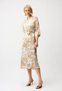 Woman wearing a beige and white floral dress on a white background