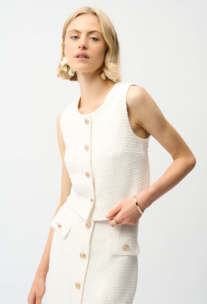 Woman wearing a white sleeveless top and skirt set on a light gray background