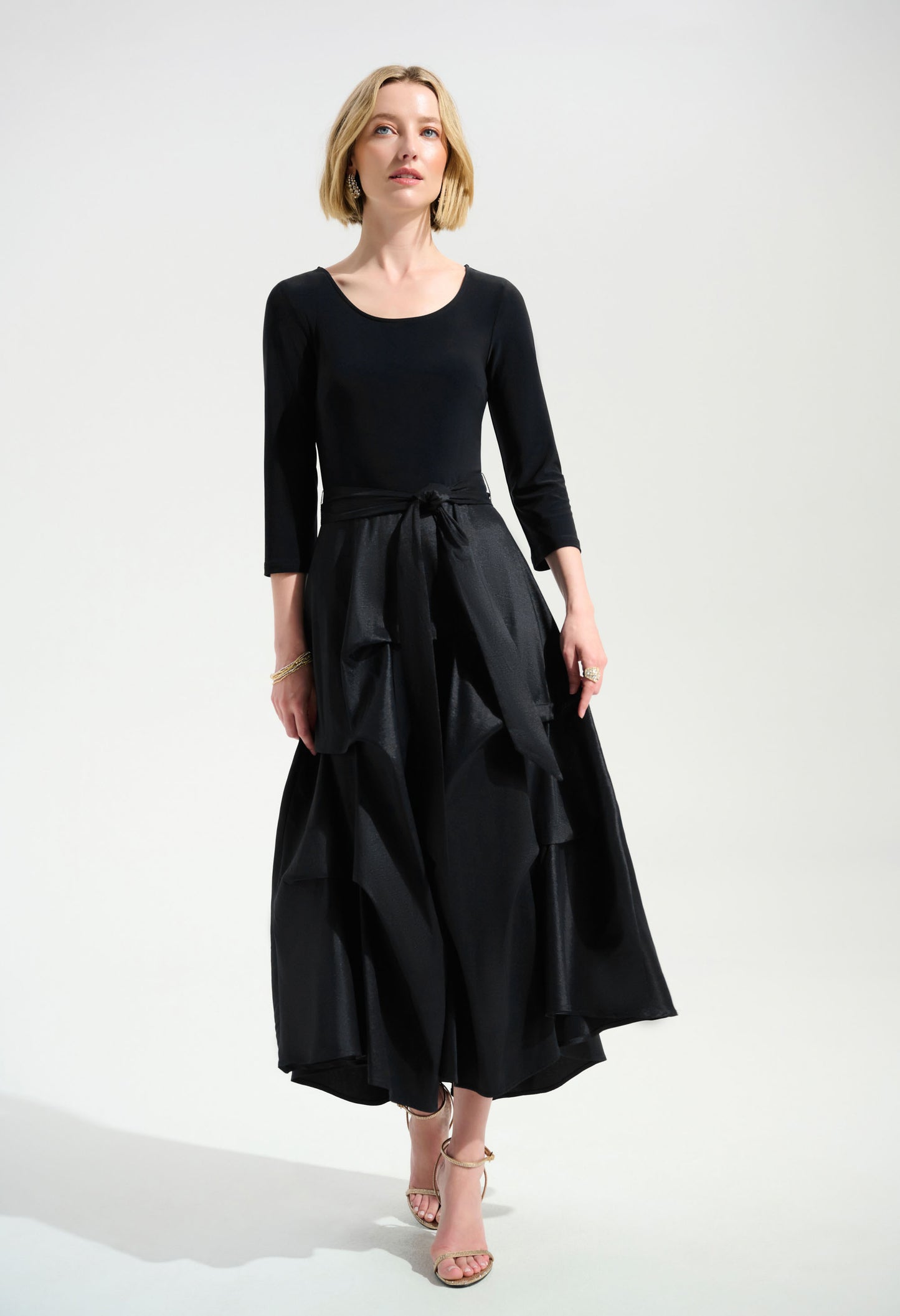 Woman wearing a black dress with a white background