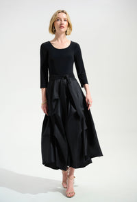 Woman wearing a black dress with a white background