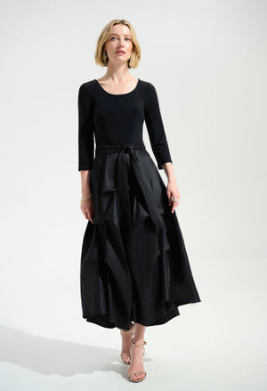 Woman wearing a black dress with a white background