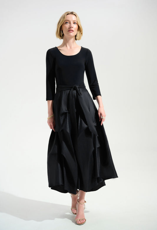 Woman wearing a black dress with a white background