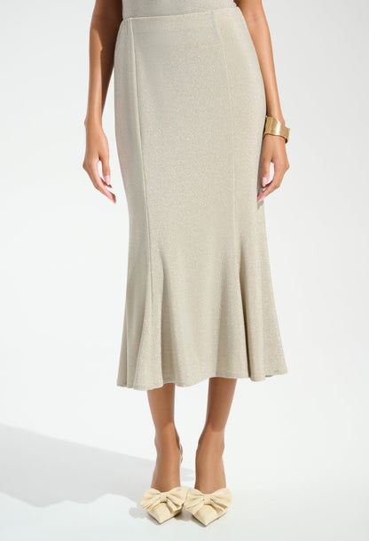 Woman wearing a beige skirt and matching shoes on a white background