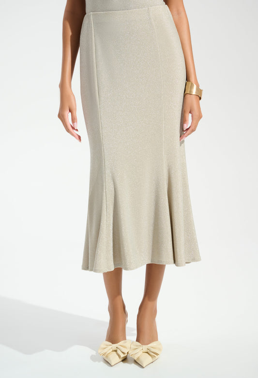 Woman wearing a beige skirt and matching shoes on a white background